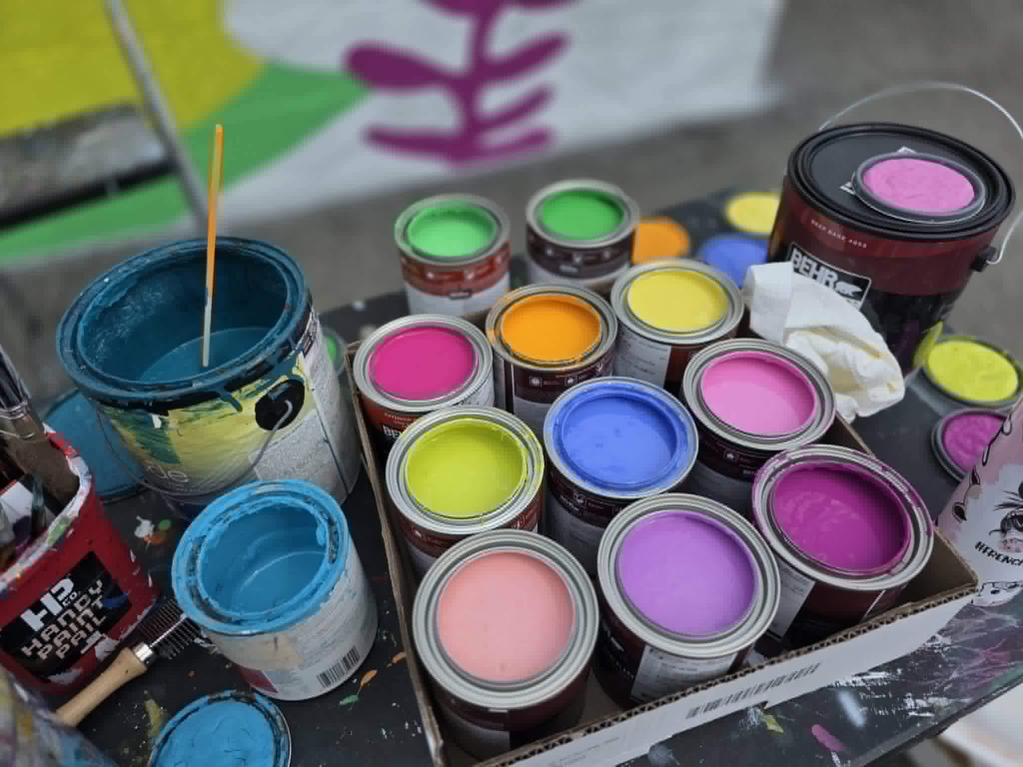 The My Sweet Escape paint party studio with neon sign, easels, and tables set up