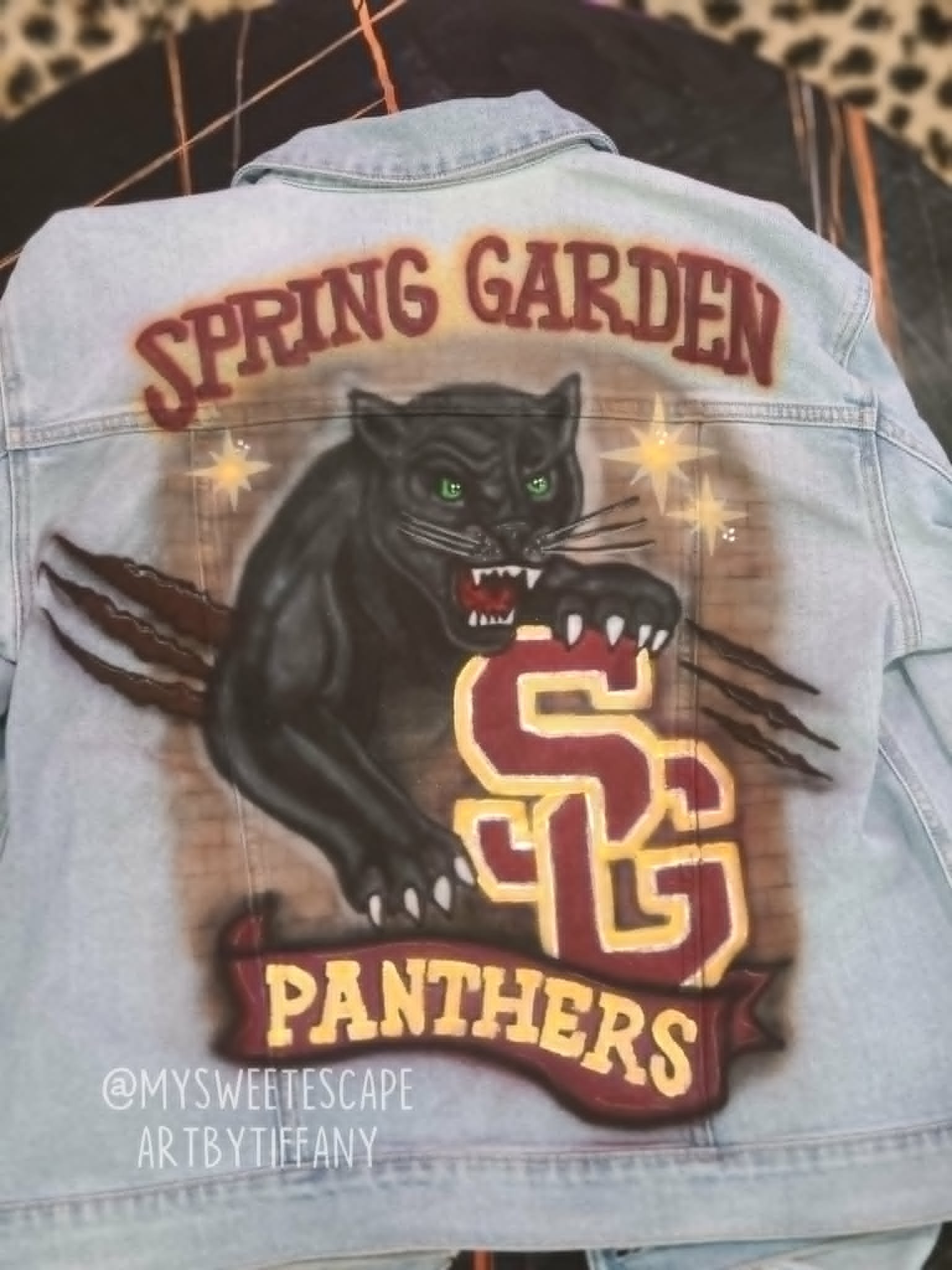 Custom hand-painted Spring Garden Panthers denim jacket with black panther, claw marks, and SG Panthers banner logo
