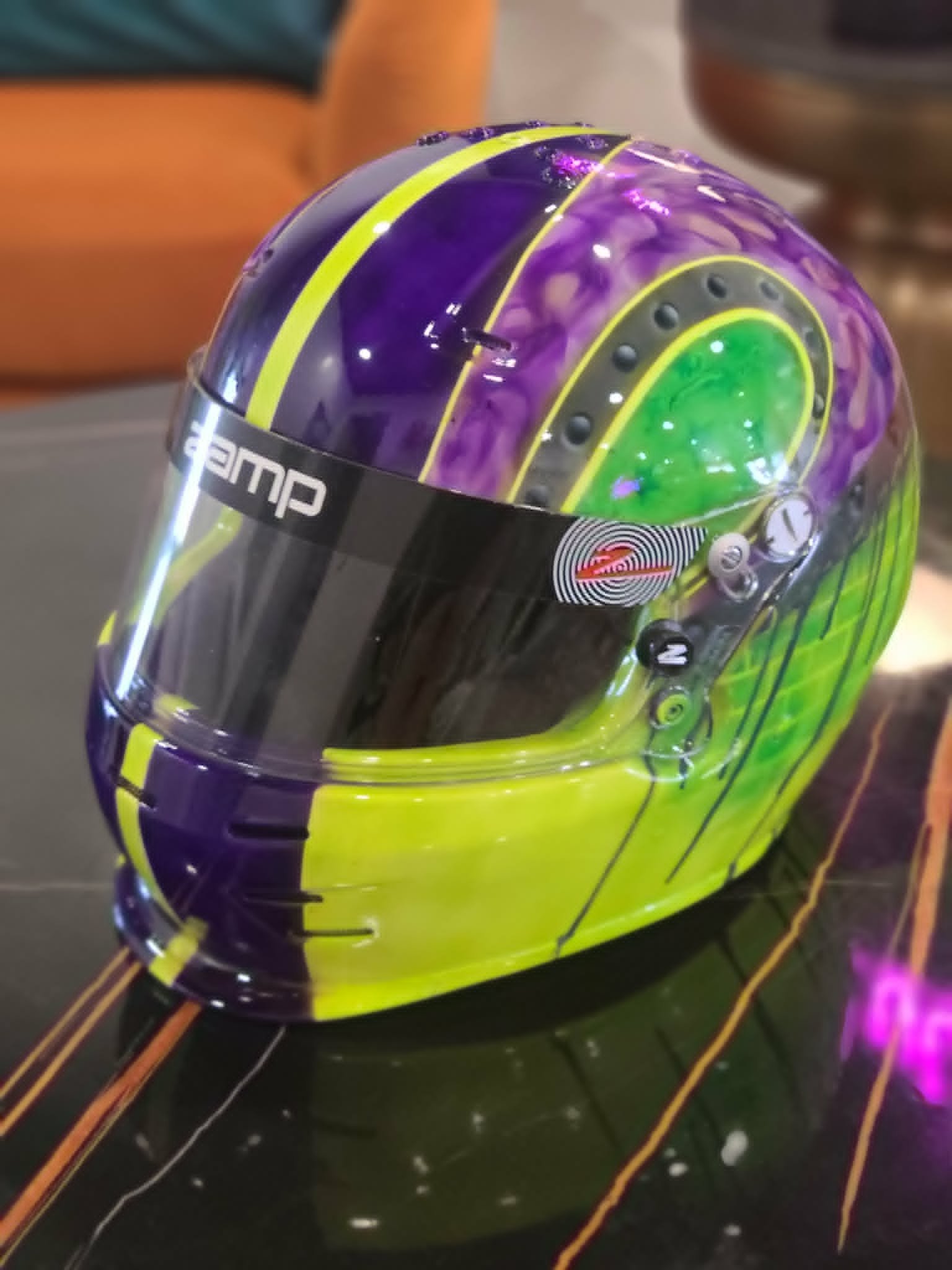 Custom airbrushed Zamp racing helmet with purple, neon yellow, and green swirl design