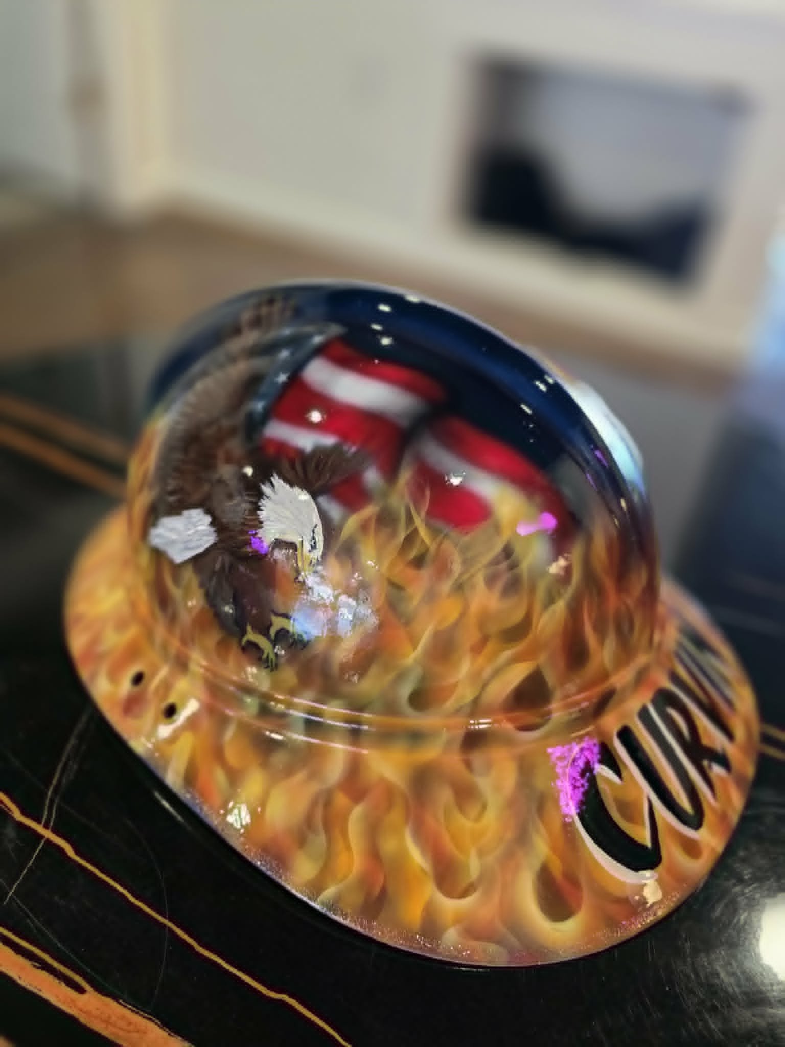 Custom airbrushed patriotic hard hat with bald eagle, American flag, and realistic flames