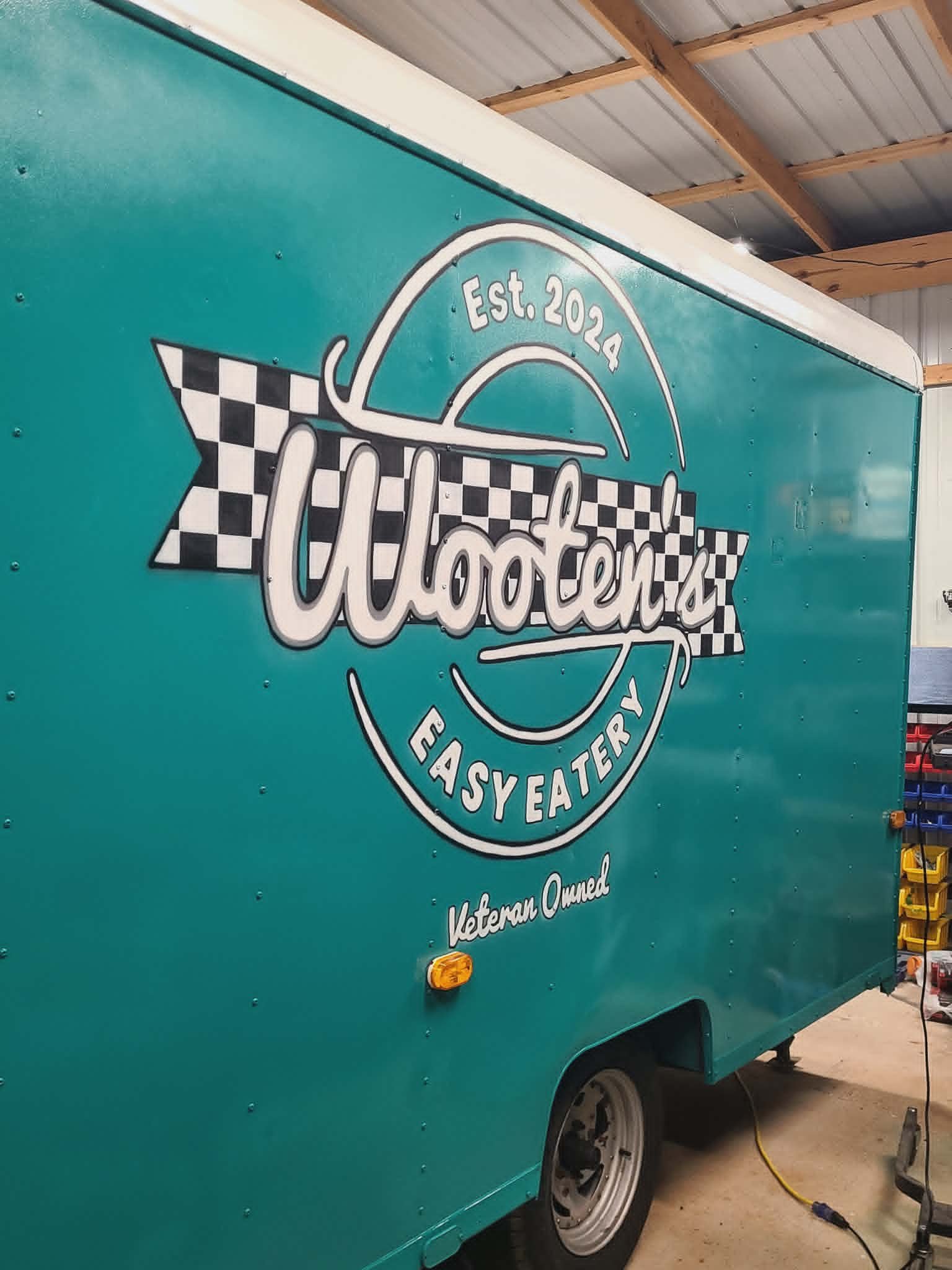 Teal food trailer painted with the full Wooten's Easy Eatery logo, Est. 2024 banner, and 'Veteran Owned' script lettering