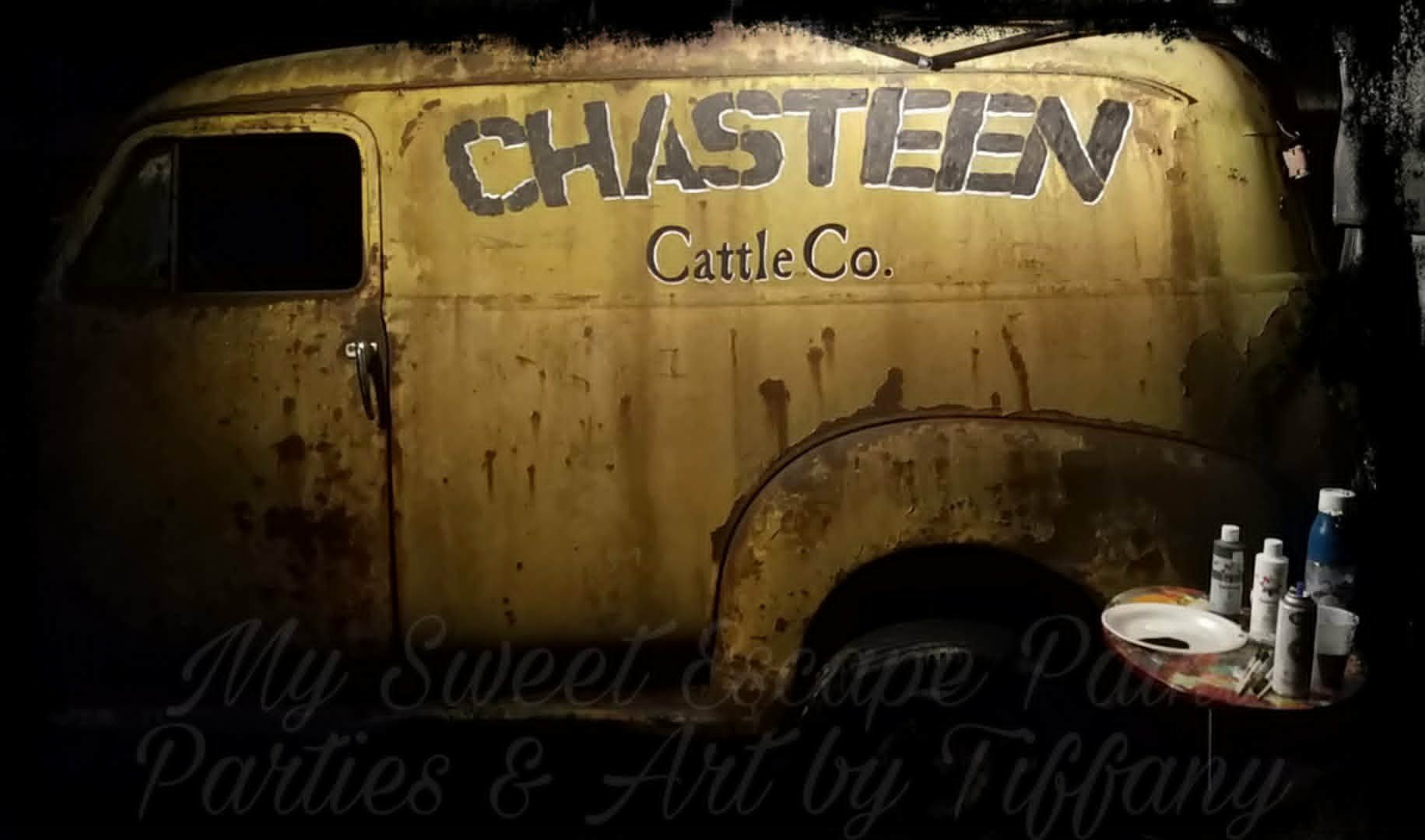Hand-painted weathered vintage panel truck with rustic stenciled 'Chasteen Cattle Co.' lettering for a Jurassic Park-style display piece