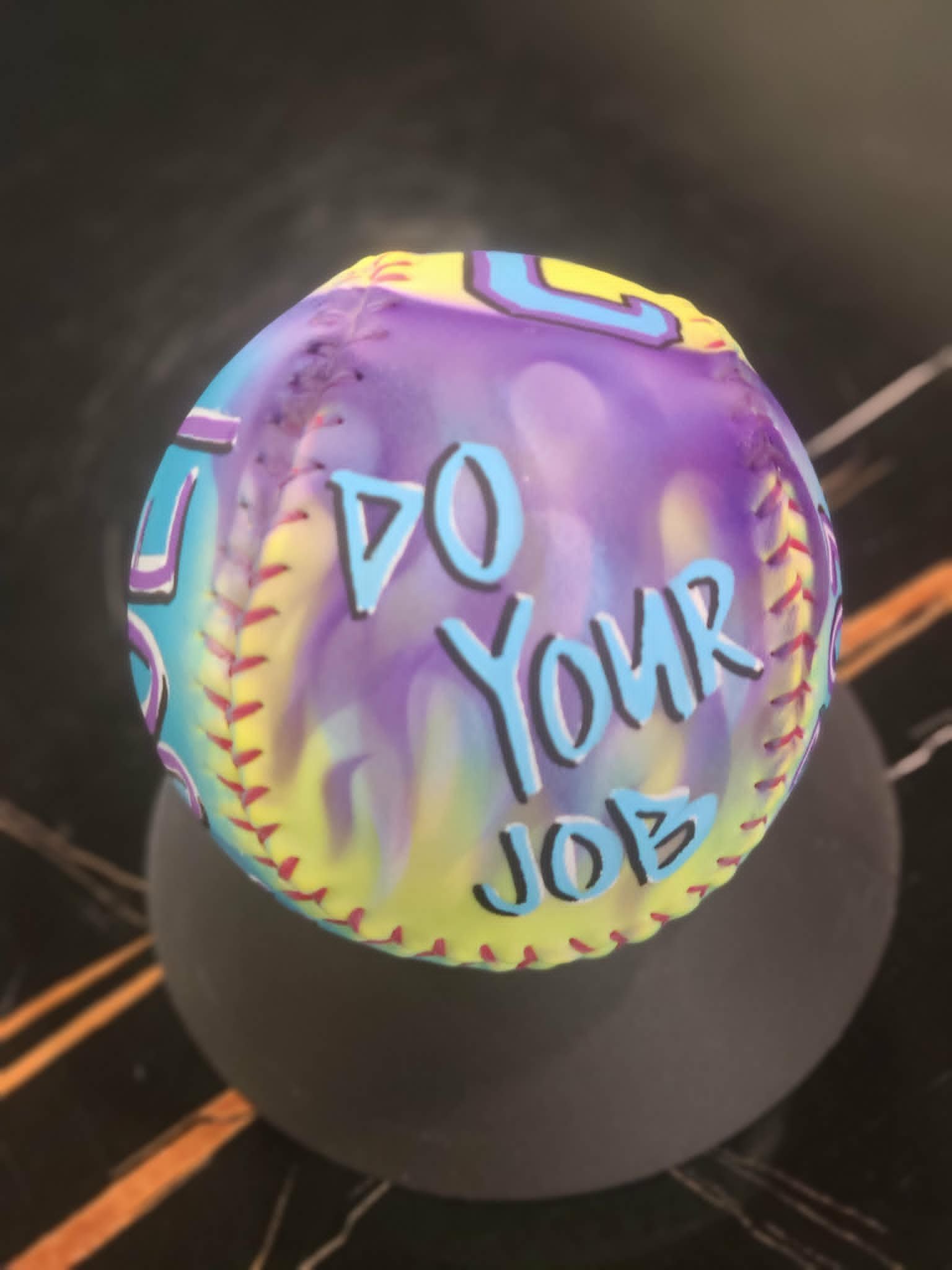 Airbrushed softball with purple, yellow, and blue flame fade and 'Do Your Job' graffiti lettering