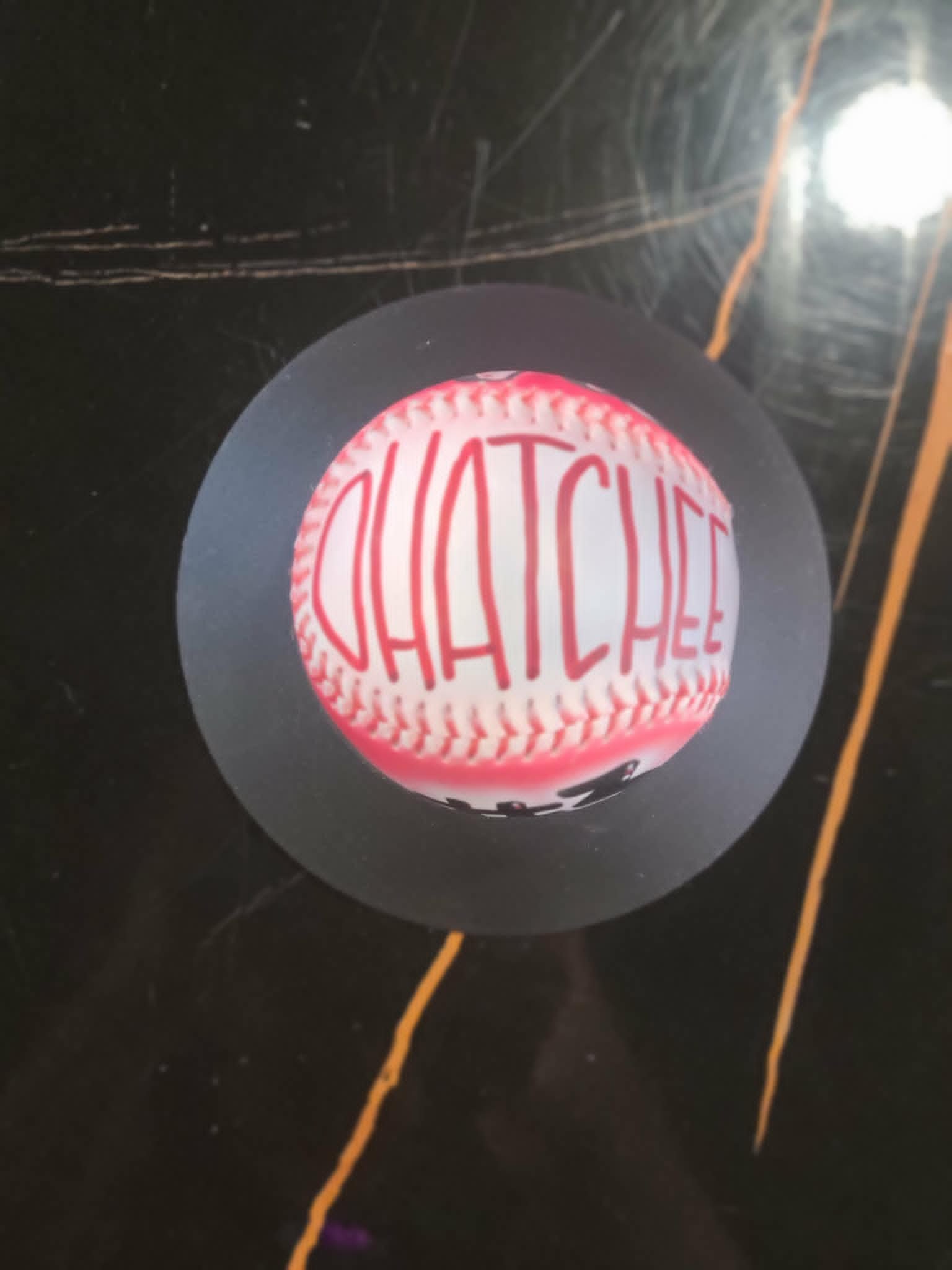 Airbrushed pink and white baseball with 'Ohatchee' team name in tall red graffiti lettering