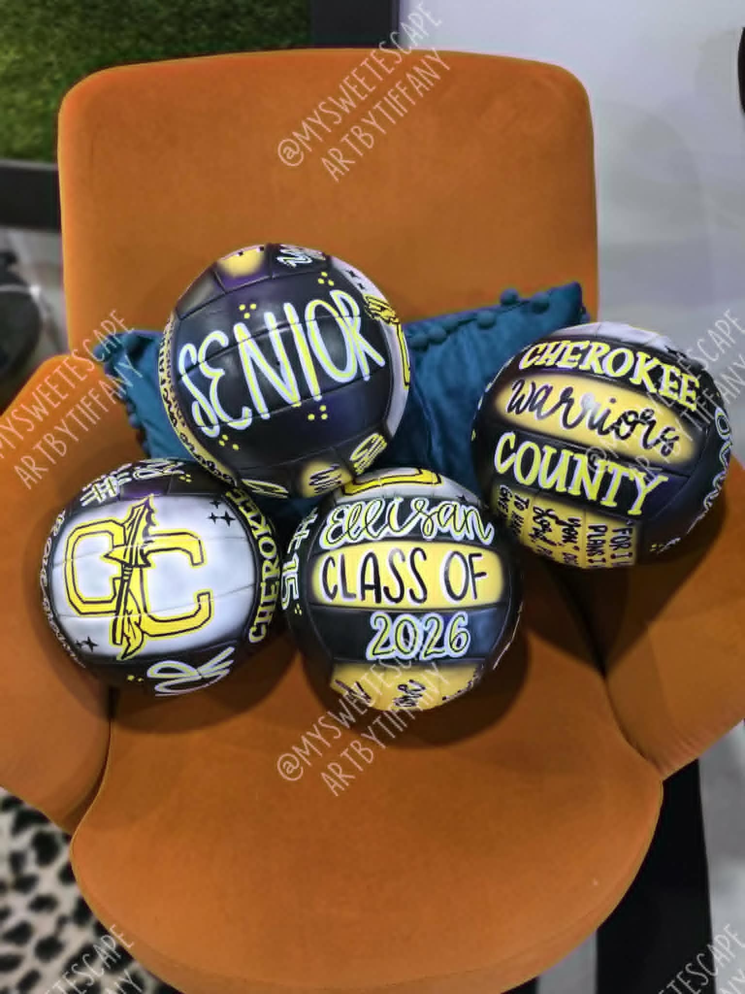 Set of four hand-painted Cherokee County Warriors senior volleyballs in purple, yellow, and white, including 'Class of 2026' and 'Senior' designs