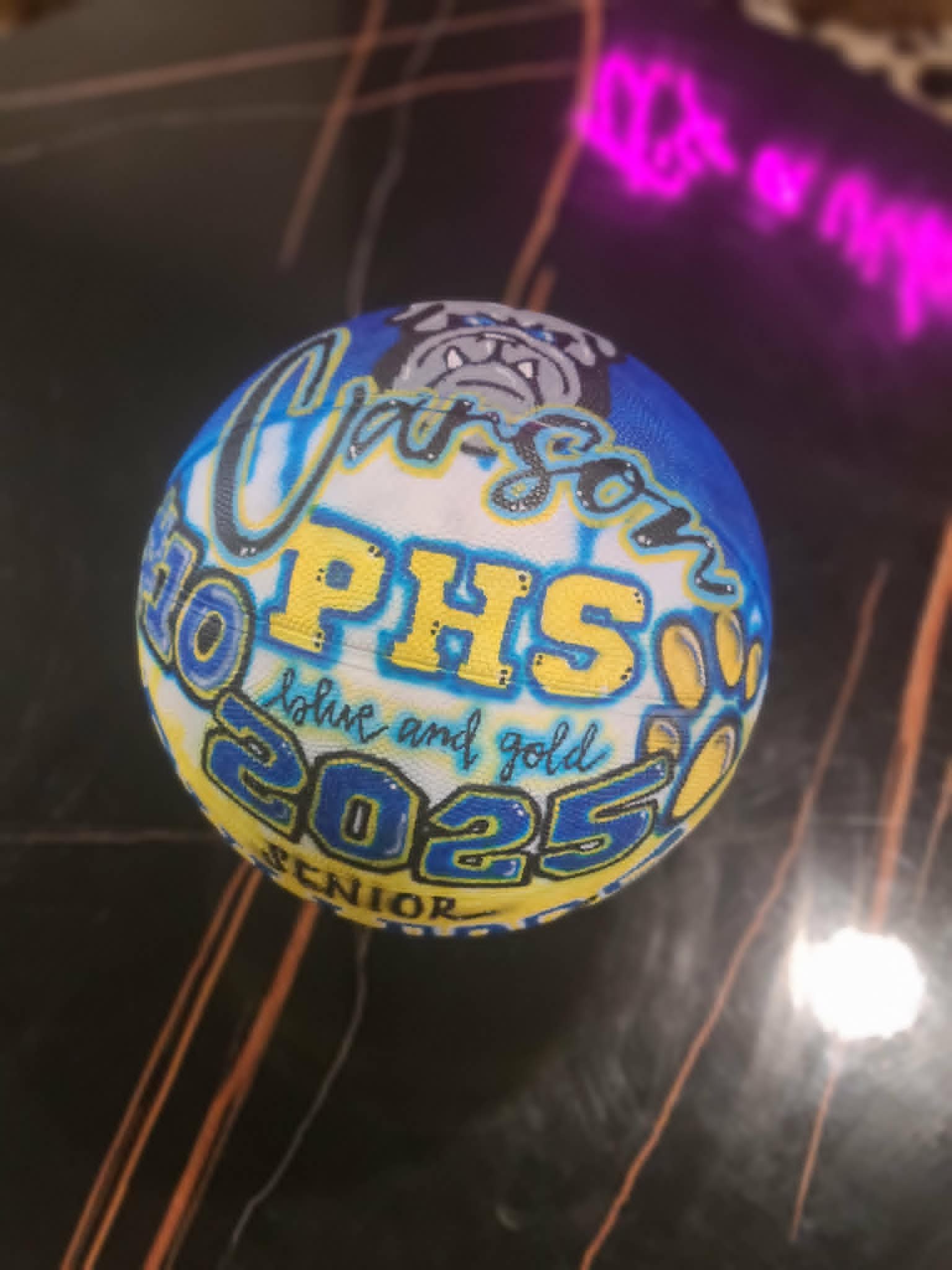 Hand-painted basketball for Carson with PHS Bulldogs mascot, 'blue and gold' script, and Class of 2025 in school colors