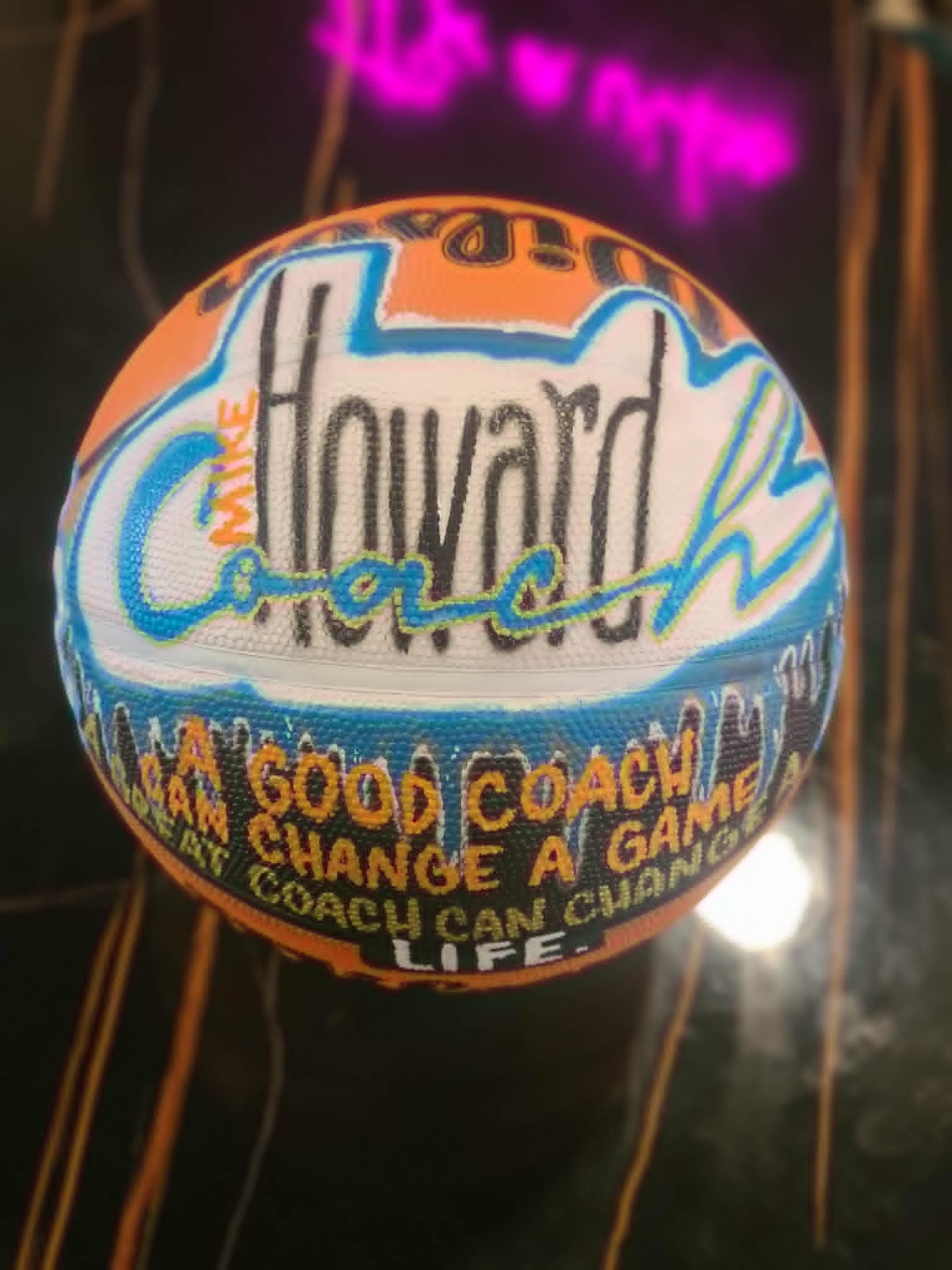 Hand-painted coach's basketball for Mike Howard with bold graffiti lettering and 'A good coach can change a game, a great coach can change a life' quote