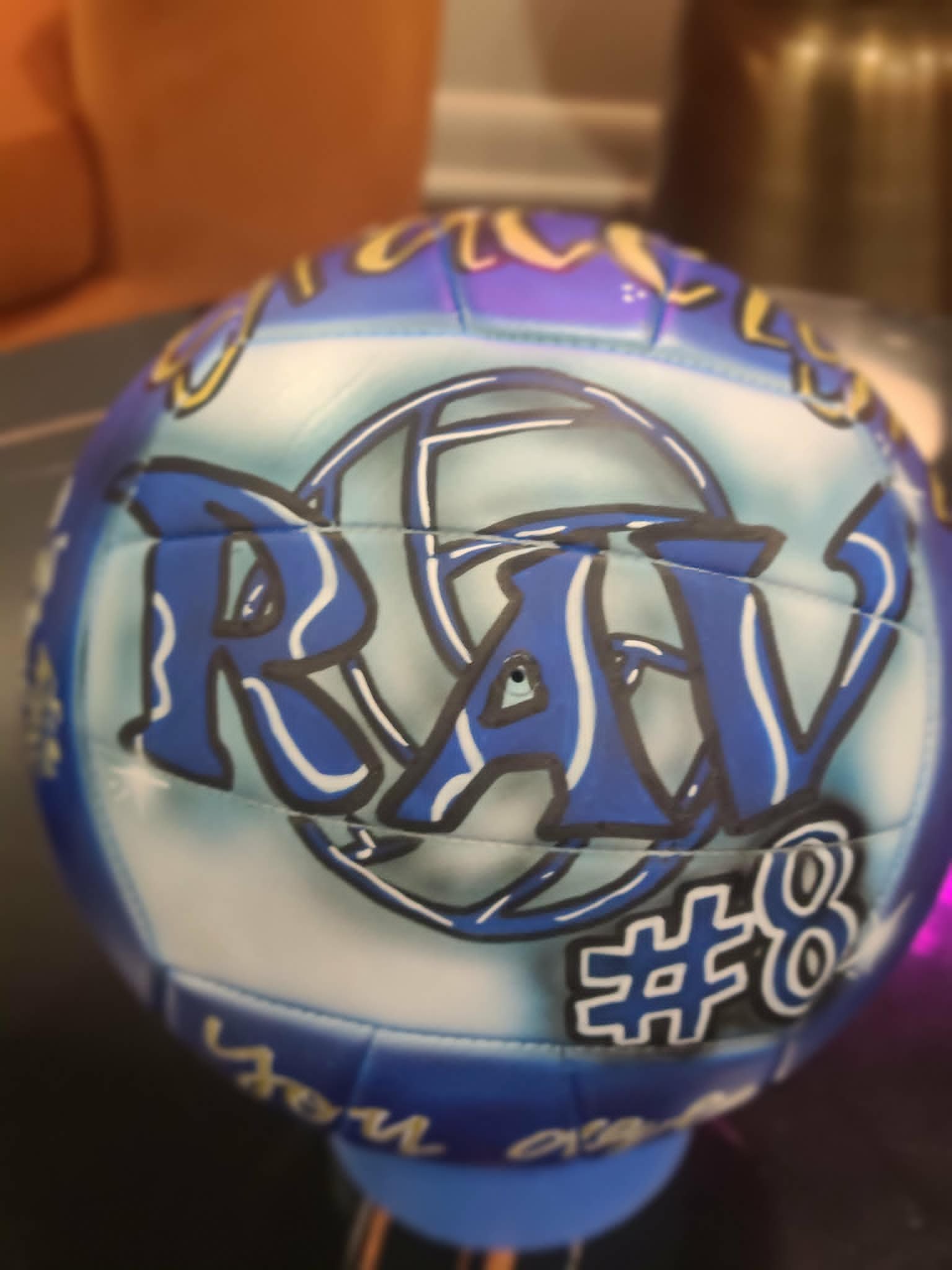 Hand-painted blue and purple volleyball with 'Ryan #8' graffiti lettering and large volleyball outline detail