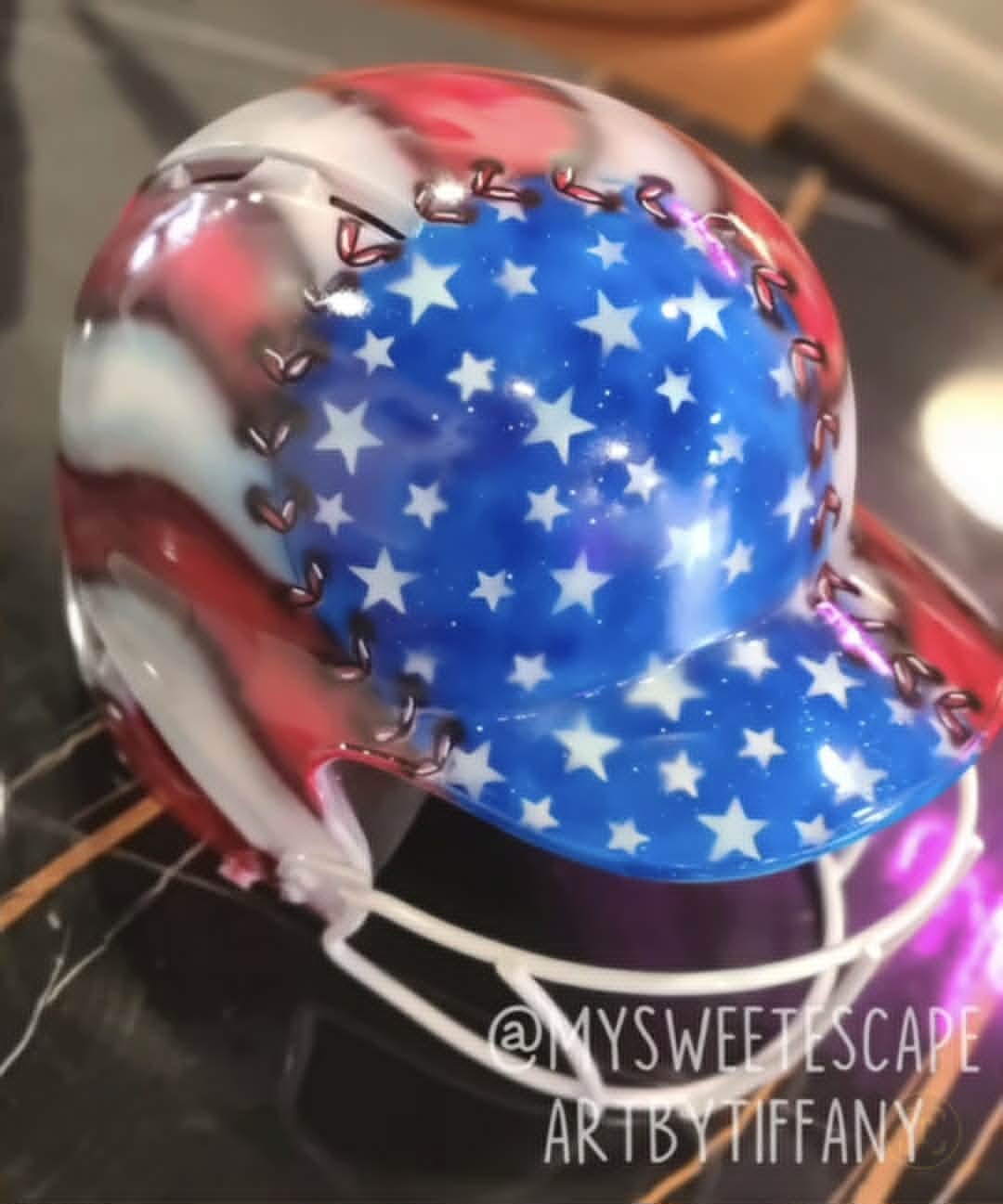 Custom airbrushed patriotic batting helmet painted as a baseball with American flag stars and stripes design