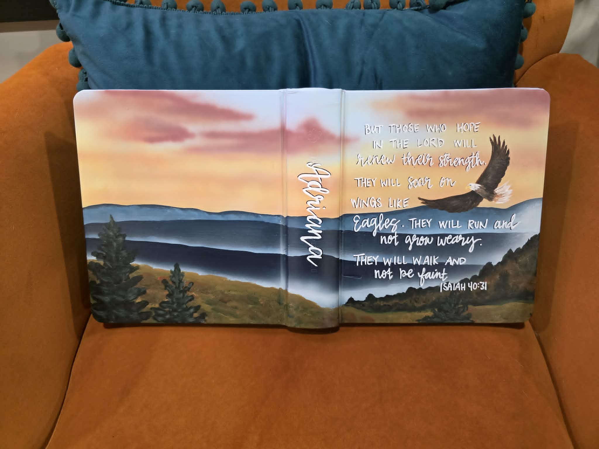 Hand-painted Bible cover for Adriana with airbrushed mountain sunset, soaring eagle, and Isaiah 40:31 verse in white script