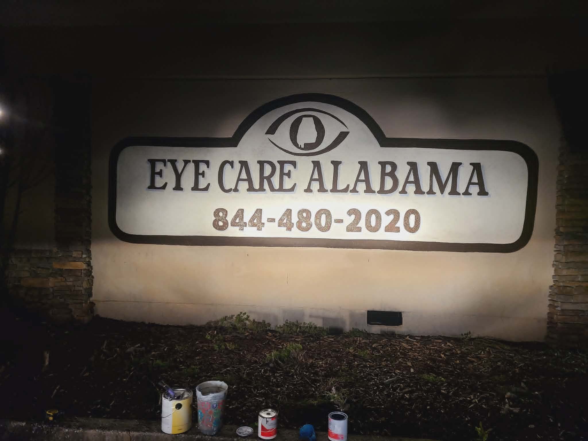 Hand-painted Eye Care Alabama exterior monument sign with the company logo, Alabama state outline inside the eye icon, and phone number