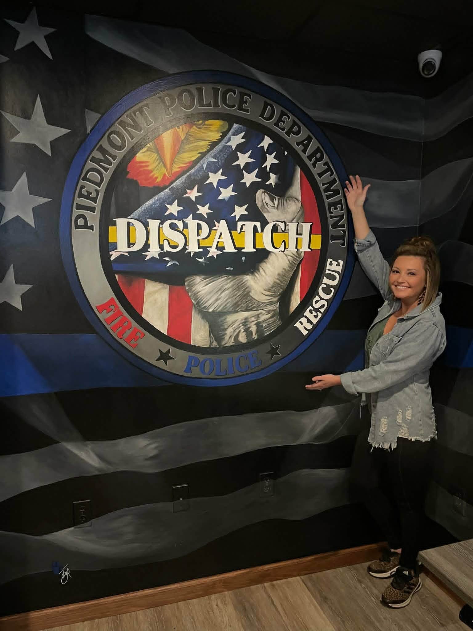 Piedmont Police Department Dispatch interior mural with a thin blue line American flag background and a detailed eagle and flag dispatch badge