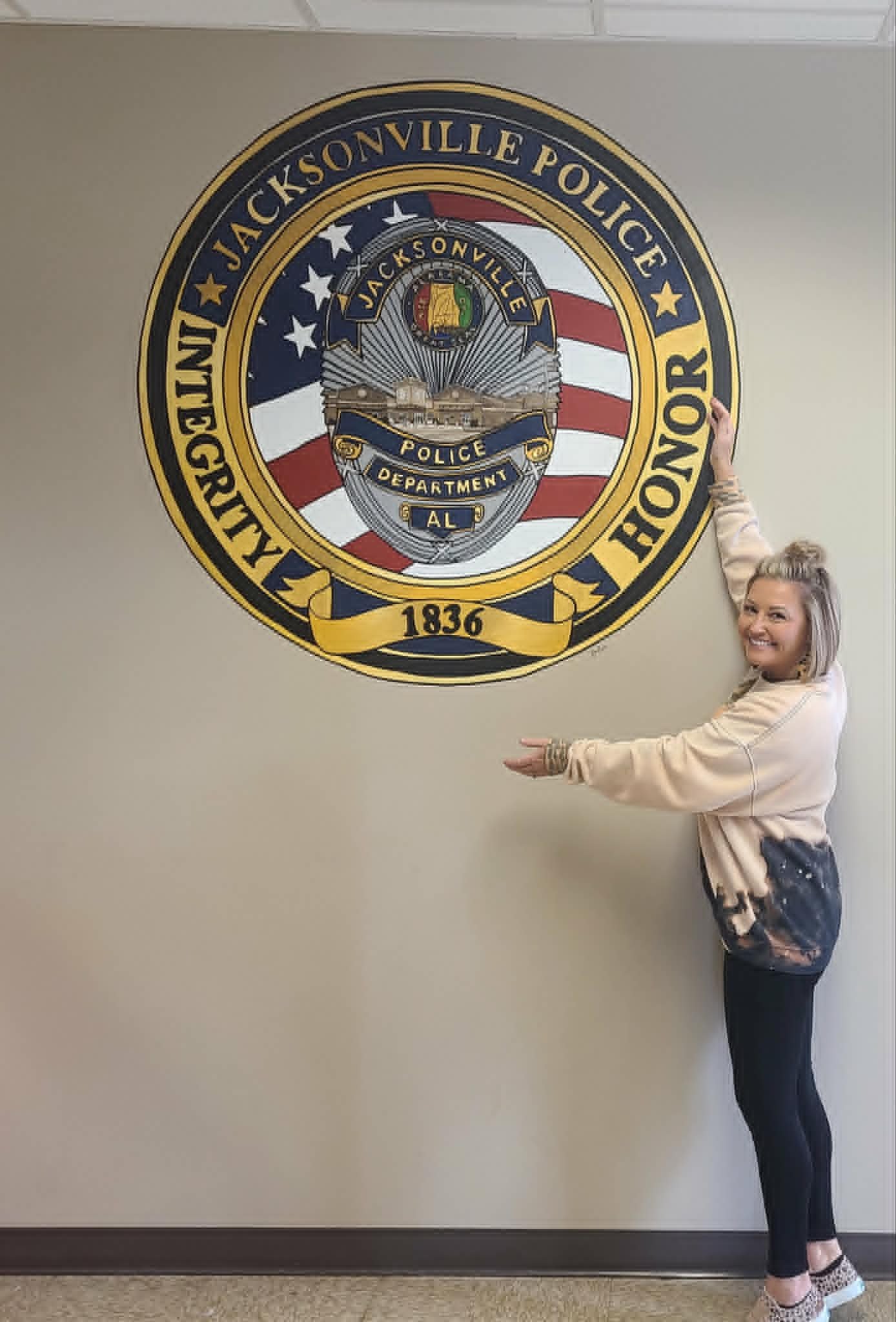 Jacksonville Police Department interior mural featuring the department's badge with American flag detailing and 'Integrity Honor 1836' lettering around the seal