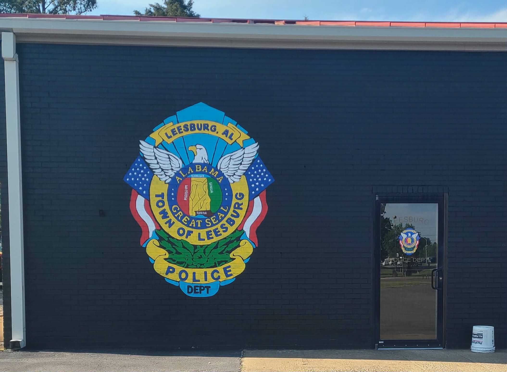 Town of Leesburg, AL Police Department badge mural with eagle, flags, and Alabama state outline