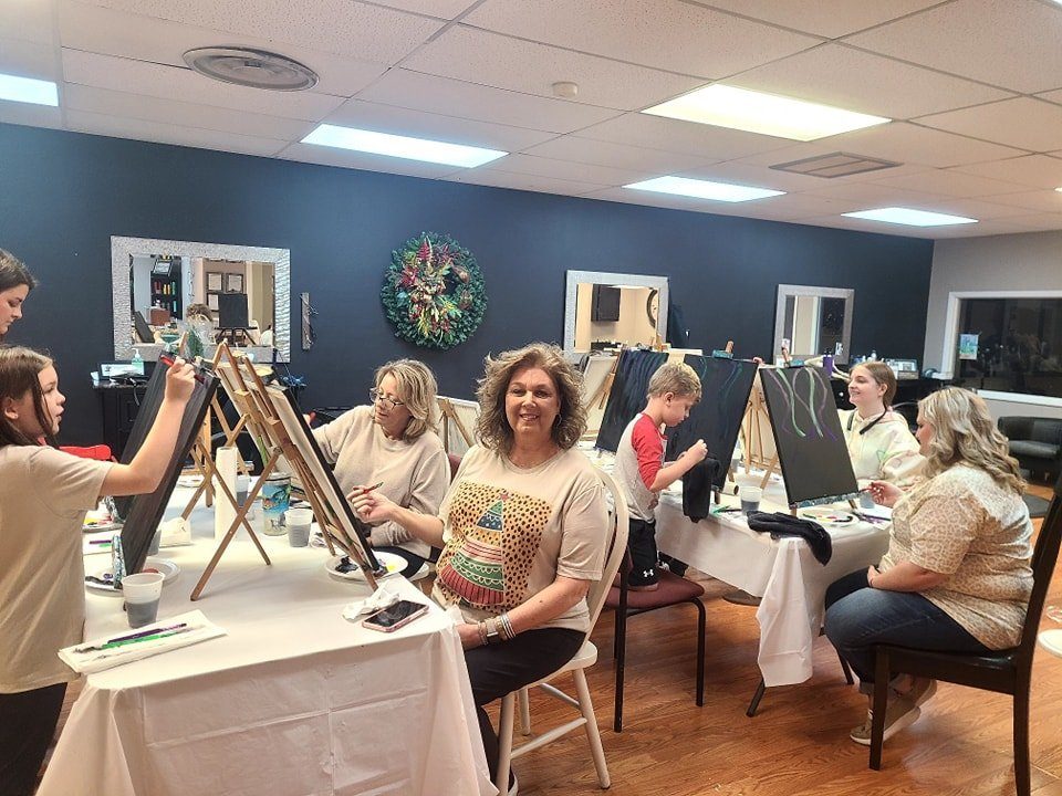 Offsite paint party with adults and kids painting together at a salon