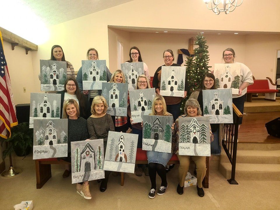 Church group posing with their finished O Holy Night winter church paintings