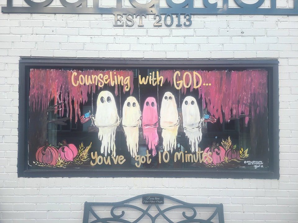 Halloween 'Counseling with God, You've got 10 minutes' window painting with five ghosts and pumpkins