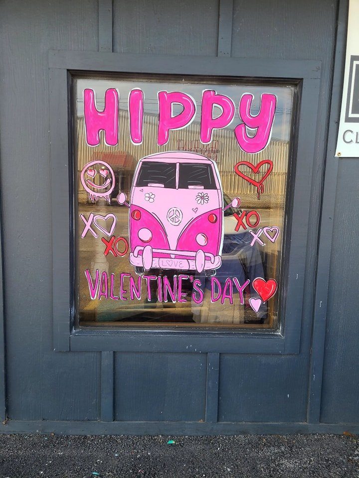 Hippy Valentine's Day window painting with pink VW van and hearts