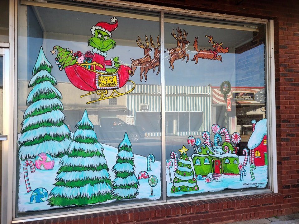 City of Piedmont storefront painted with the Grinch in a sleigh, reindeer, and snowy Whoville scene