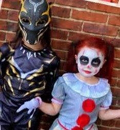 Kids in Black Panther and creepy clown costumes with painted faces