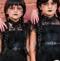 Two girls dressed as Wednesday with matching gothic makeup